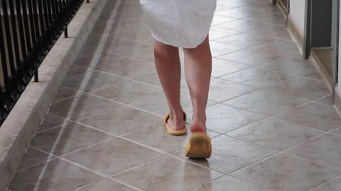Feet in flip-flops heading to the beach in the summer walking through the hotel Stock Footage 327071813