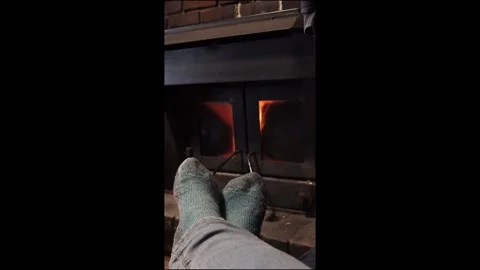 Feet in front of fireplace V Stock Footage 328742232