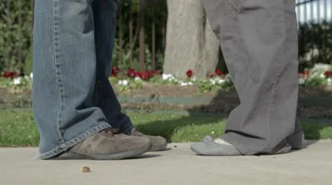Feet in front of Flower Bed Stock Footage 10773319