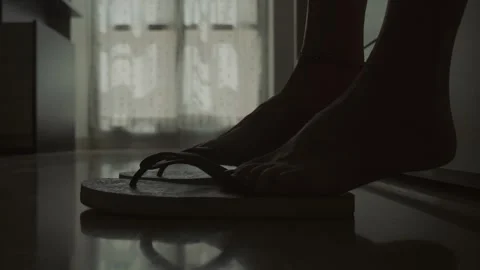 Feet getting out of bed and putting on flip-flops in the morning Stock Footage 287136070