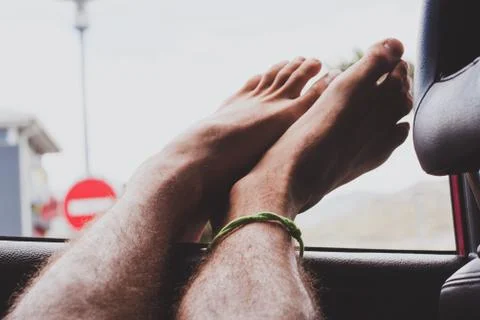 Feet hanging out car window Stock Photos