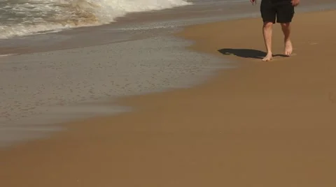 Feet, Legs walking through waves on the beach Stock Footage 53859791