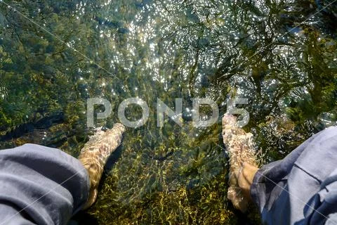 Feet in the Limpid and Clear Water Stock Photos