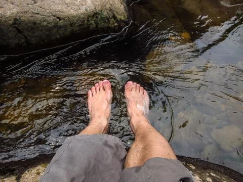 Feet in the Limpid Stream Stock Photos