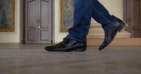 Feet of man in black shoes. Man walks in the old University Stock Footage