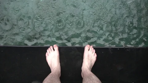 Feet of the man staying on the edge of the pool in Bali. Stock Footage 104334087