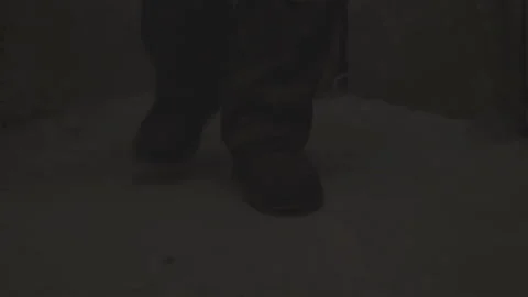 The feet of a man walking down the dark corridor of an old abandoned basement Stock Footage 153091950