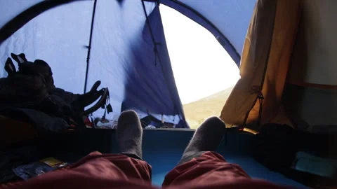 Feet of a man in wool socks lying in a tent. Stock Footage 97758337