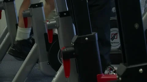 Feet Peddling Exercise Bikes in Gym Stock Footage 7728161