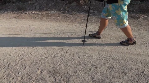 Feet of a pilgrim who goes on an unpaved road. Is hot outside, he wears short 19 Stock Footage 59841153
