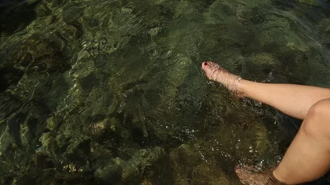 Feet playing with water Stock Footage 114801943