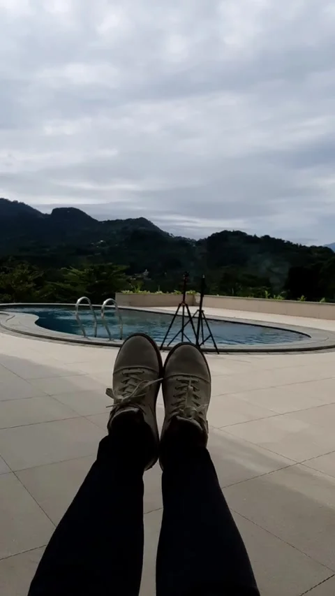 Feet at Poolside Overlooking Mountains Stock Footage 331420015