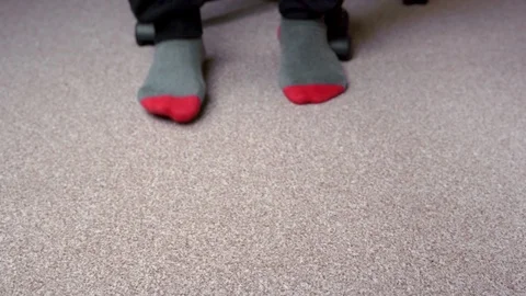 Feet in red-grey socks on a light brown carpet Stock-Footage 124552480