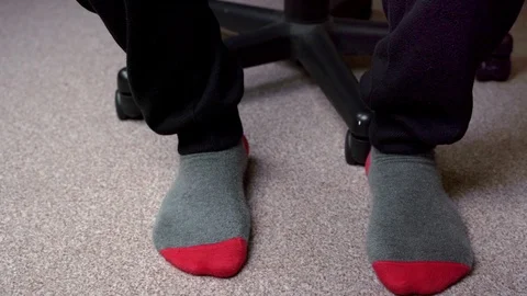 Feet in red-grey socks on a light brown carpet Stock-Footage 124575486