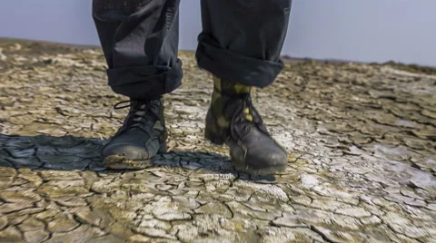 Feet Of Researcher Walking On Split Soil At Valley Stock Footage 50127033