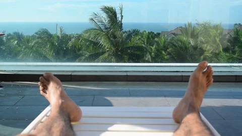 Feet rest on coconut tree background Stock Footage 90784471