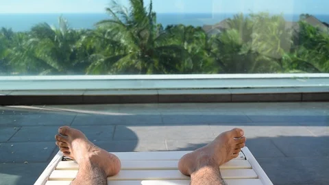 Feet rest on coconut tree background Stock Footage 90784484