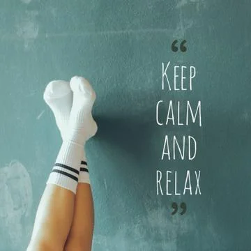 Feet rest on wall with message Keep calm and relax Stock Photos