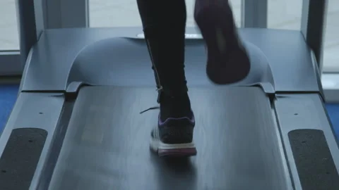 Feet running on a treadmill Stock Footage 235441766