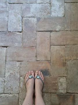 Feet on the rustic brick path Stock Photos