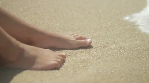 Feet in sand and waves Stock Footage 7750307