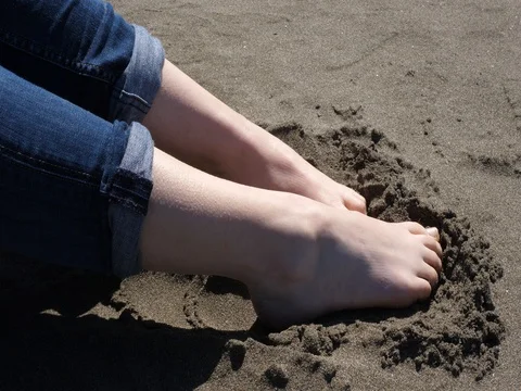 Feet in sand Stock Footage 75351439