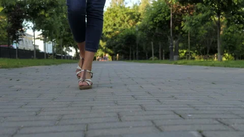 Feet in sandals step on the pavement in a model close-up gait. Stock Footage 146588140