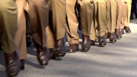 Feet of soldiers dressed in stop clothes, marching on the street during a ho Stock Footage