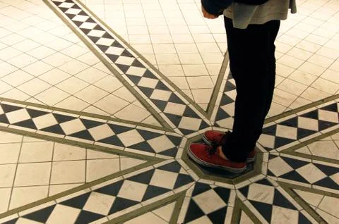 Feet on a spiral tile pattern Stock-Fotos