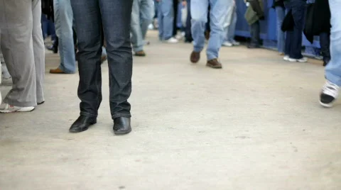 Feet standing and waiting while others walk by Stock Footage 654447