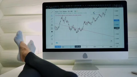 Feet on the table near the computer. Studying graphics on the computer Video stock 130896416