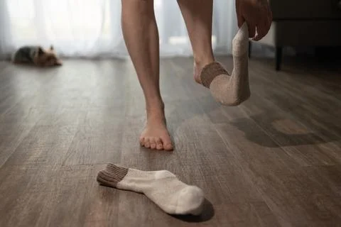 Feet Taking off Warm Socks Inside House With Underfloor Heating Stock Photos