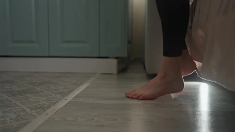 Feet transition from bed to chilly floor during peaceful morning moments Stock Footage 342061929