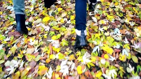 Feet of two persons in black boots walking in autumn Stock Footage 72897166
