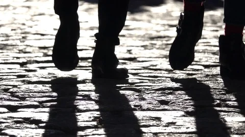 Feet Walk in Sync on Cobblestones Stock Footage 80203378