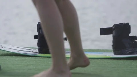 Feet walking in front of wakeboard on the dock Stock Footage 80162914