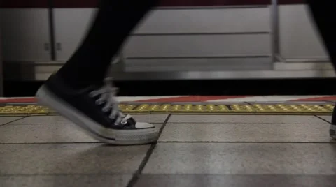 Feet walking next to train close up Japan Video stock 58960772
