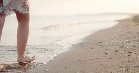 Feet walking on a sandy beach Stock Footage 133722258