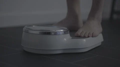 Feet on weighing scale Stock Footage 260344440