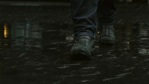 Feet on wet pavement Video stock 129464092