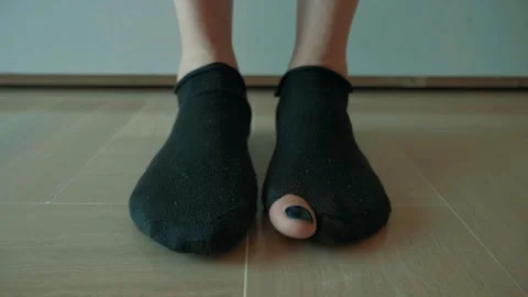 Feet in Worn Socks with Toe Sticking Out Stock Footage 279919631