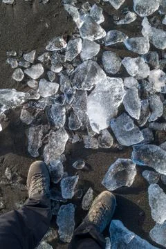 Feets on beach with small icebergs Stock Photos