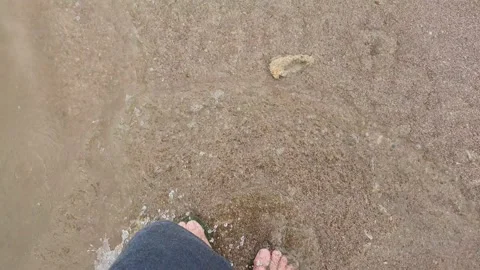 Feets of young man wearing flip flop sandals walking on the beach Stock Footage 146633595