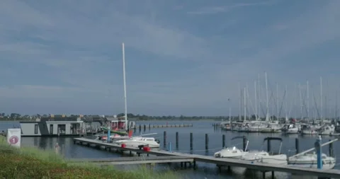 Fehmarn harbor for private boats and sailing ships panning shot at sunny day Stock Footage 284373875