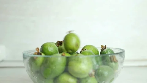 Feijoa berries fall into the plate Stock Footage 119720492