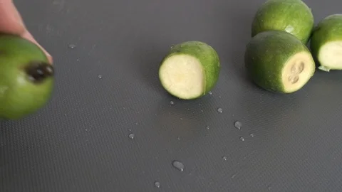 Feijoa berry cut with a knife Stock Footage 119724965