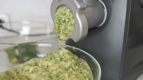 Feijoa jam flows from the meat grinder Stock Footage 119792680