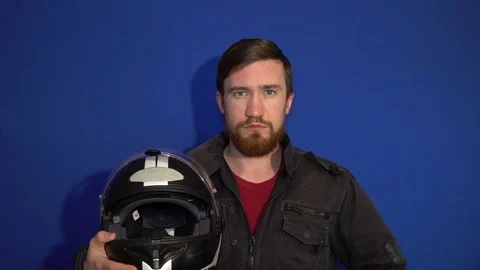 A fellow biker with a serious face wearing a helmet Stock Footage 124304744
