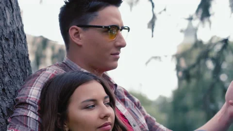 Fellow student sits under a tree in a park with a student. Relationships at the Stock Footage 138999214