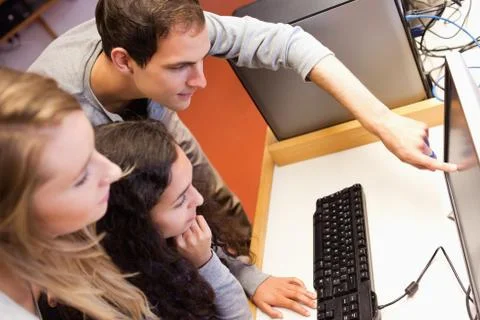 Fellow students using a computer 스톡 사진